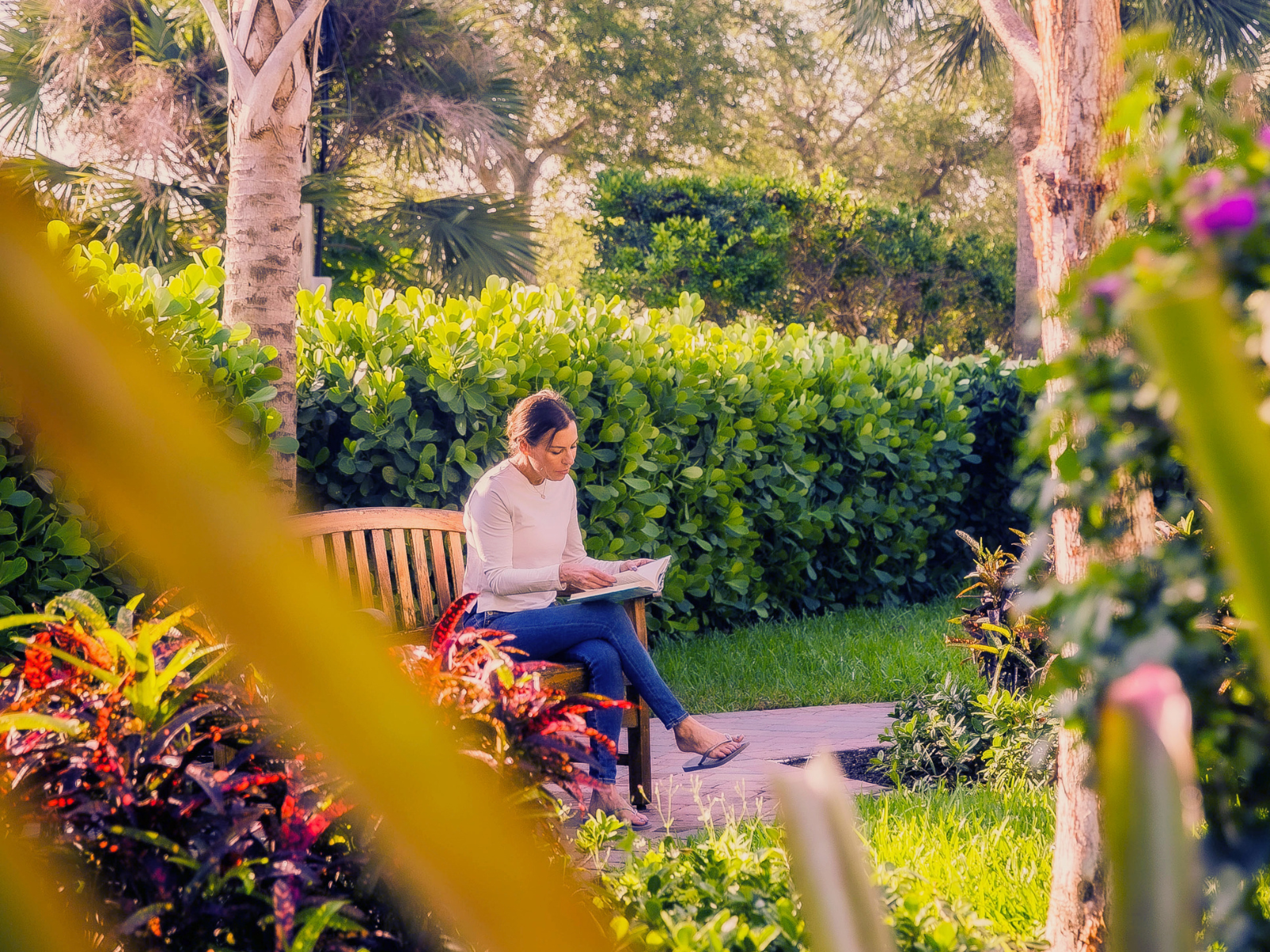 Odyssey Behavioral Healthcare - Facility Teams - Lifeskills Client Reading Outdoors